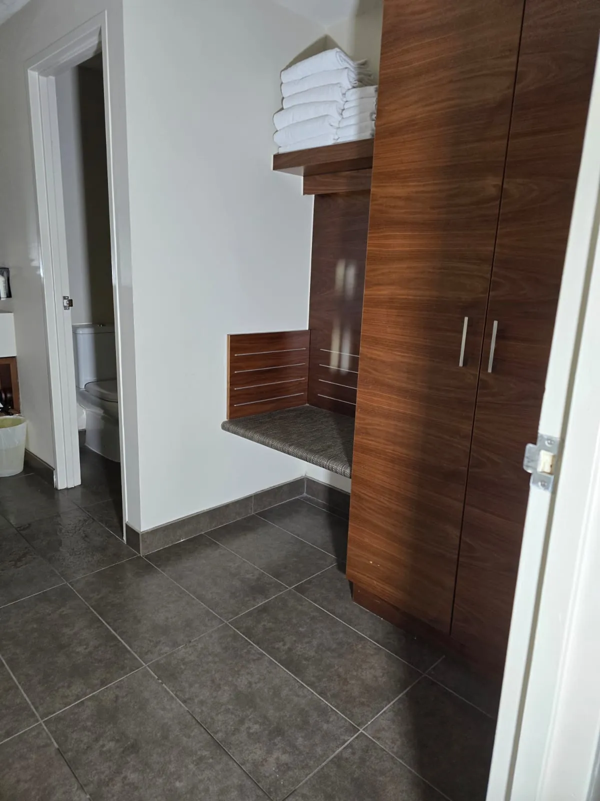 Tiled floor and joinery in an affected ensuite.