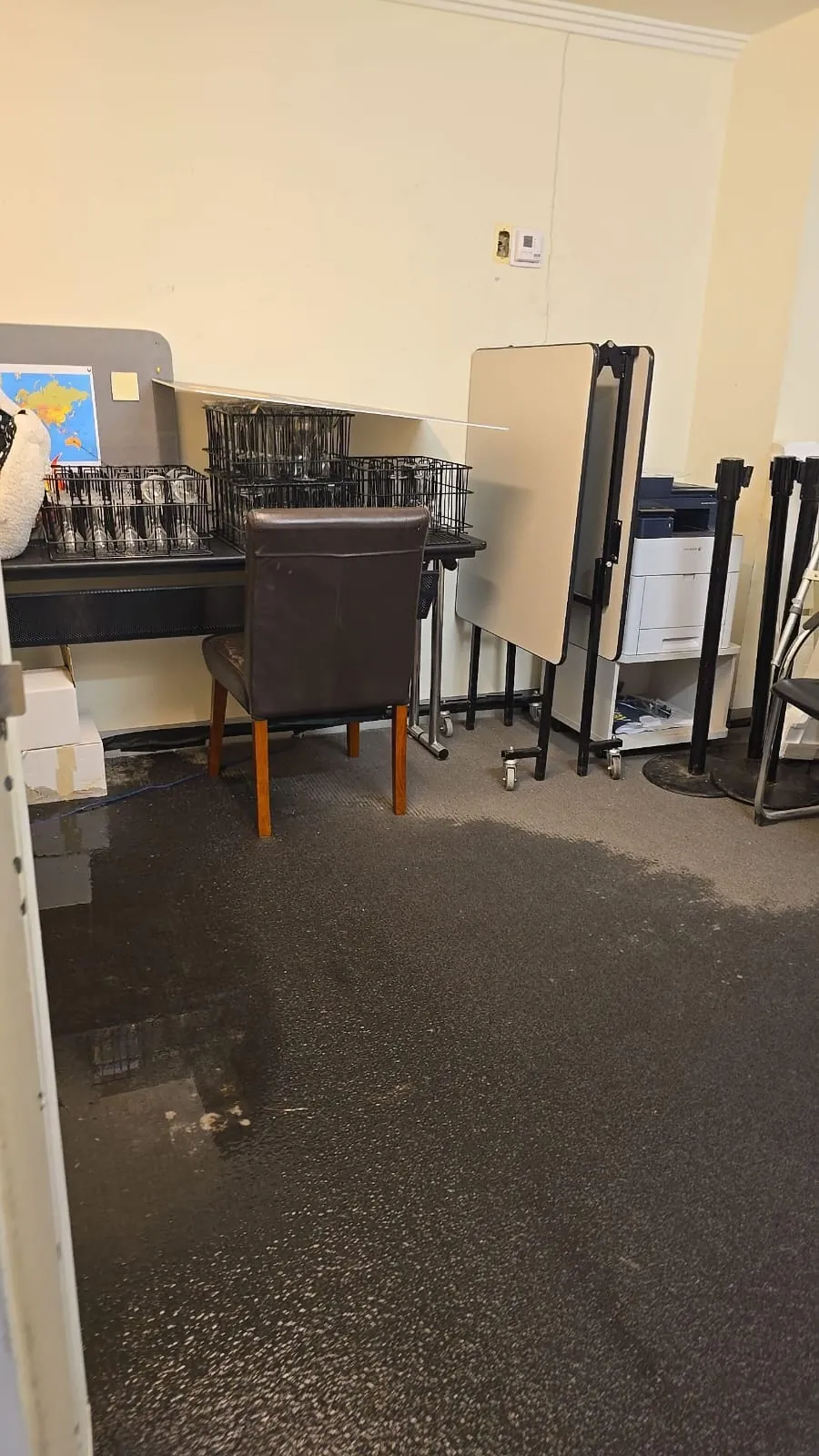 Furniture and equipment on wet carpet in the events office.