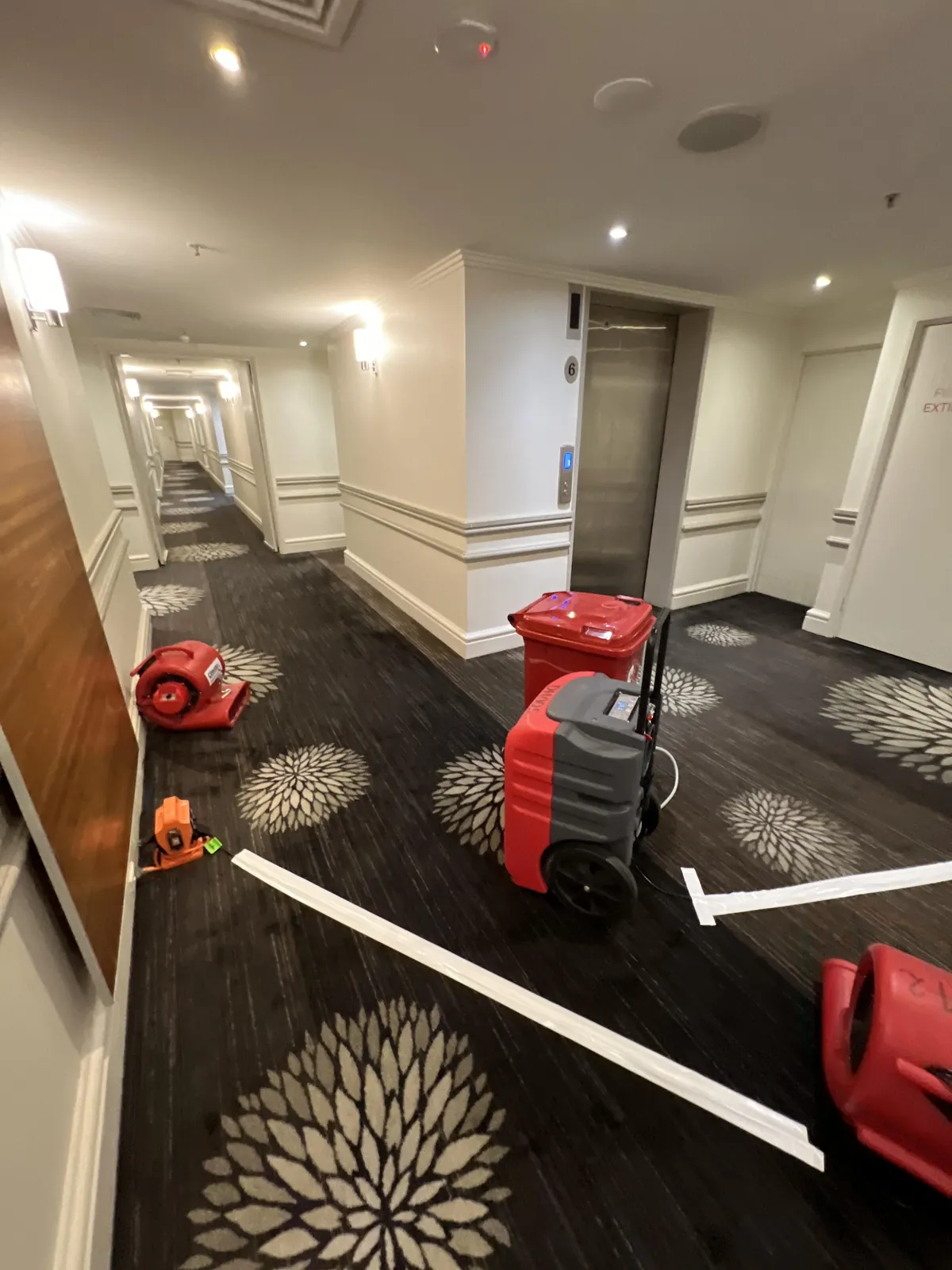 Dehumidifier and air movers in the Level 6 corridor.